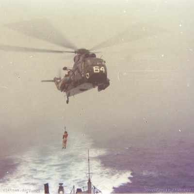 Helo lowering man to Jouett, Gulf of Tonkin