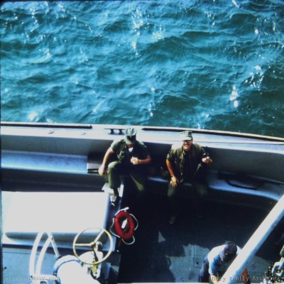 Bill Ducy departing in the utility boat, M16 in hand